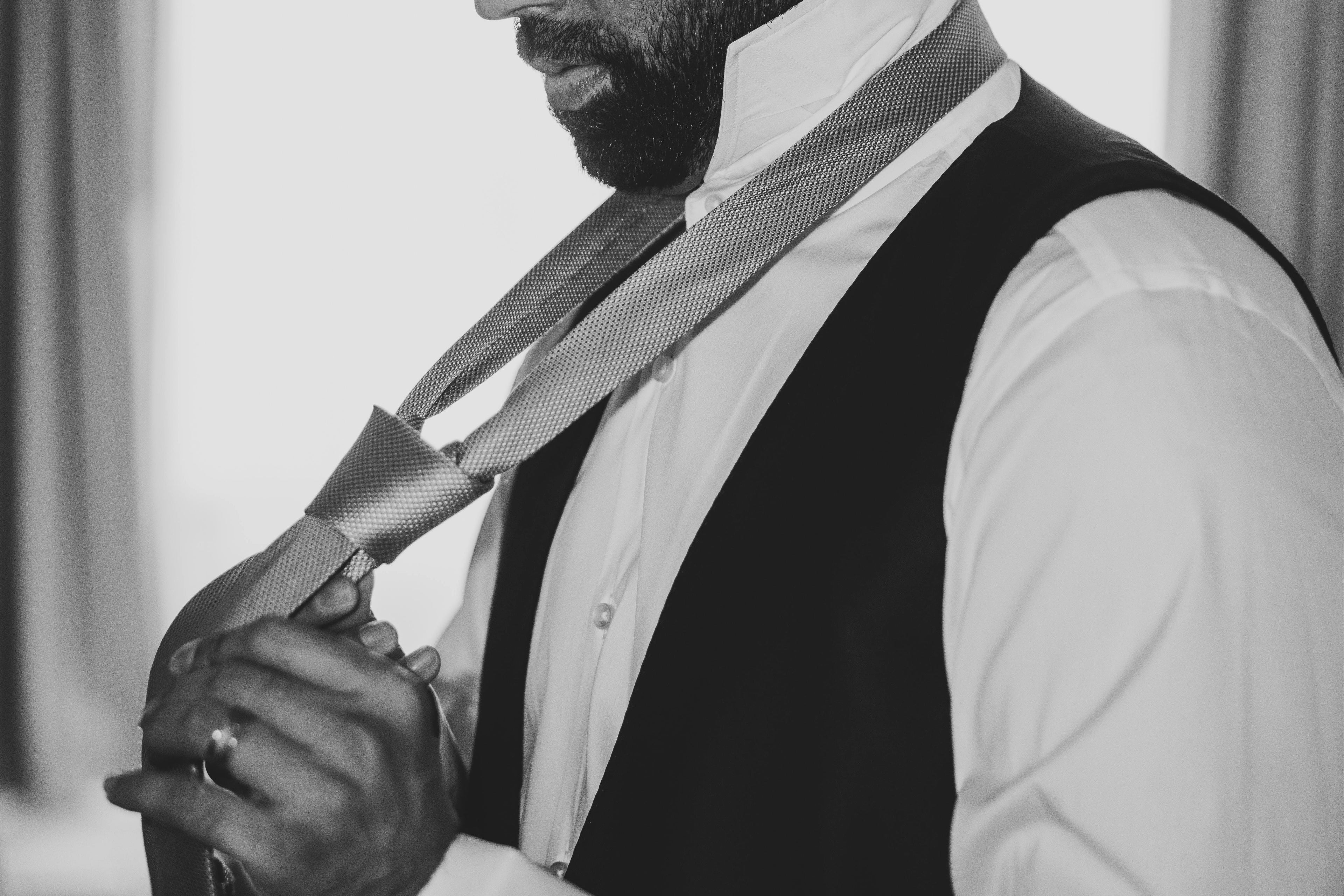 Groom playing with his tie