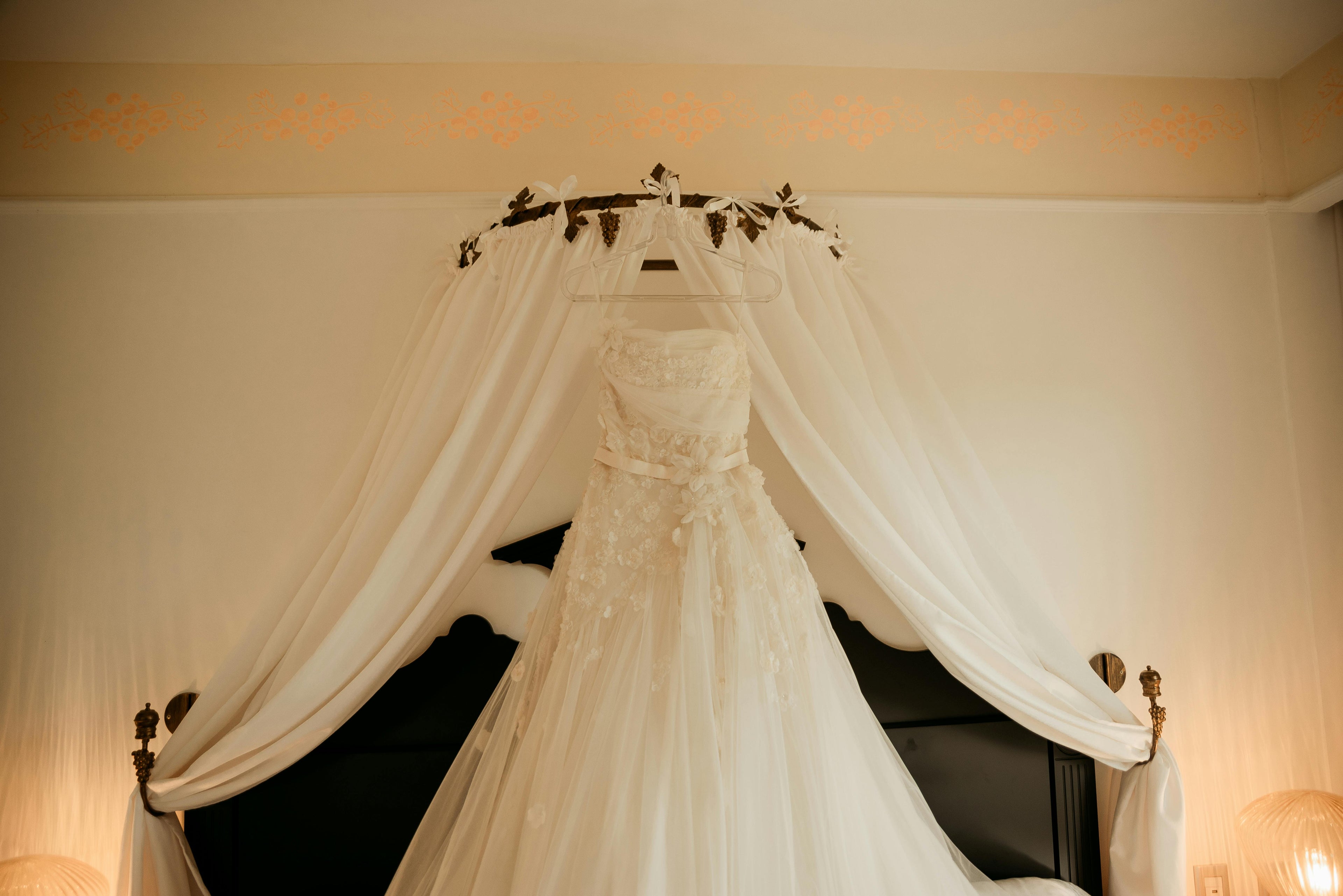 Lace wedding dress hanging in the bridal suite