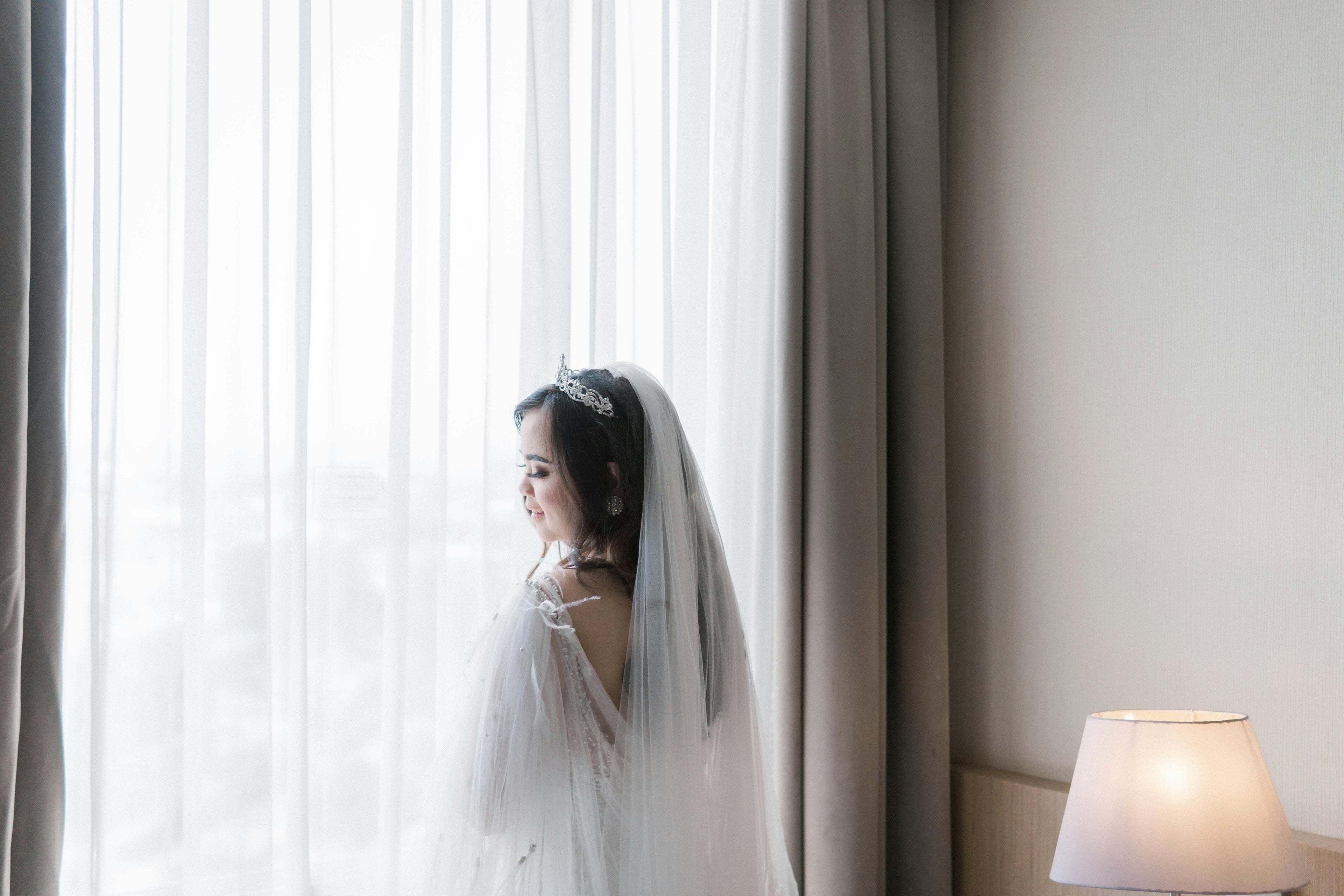 bride posing by the window