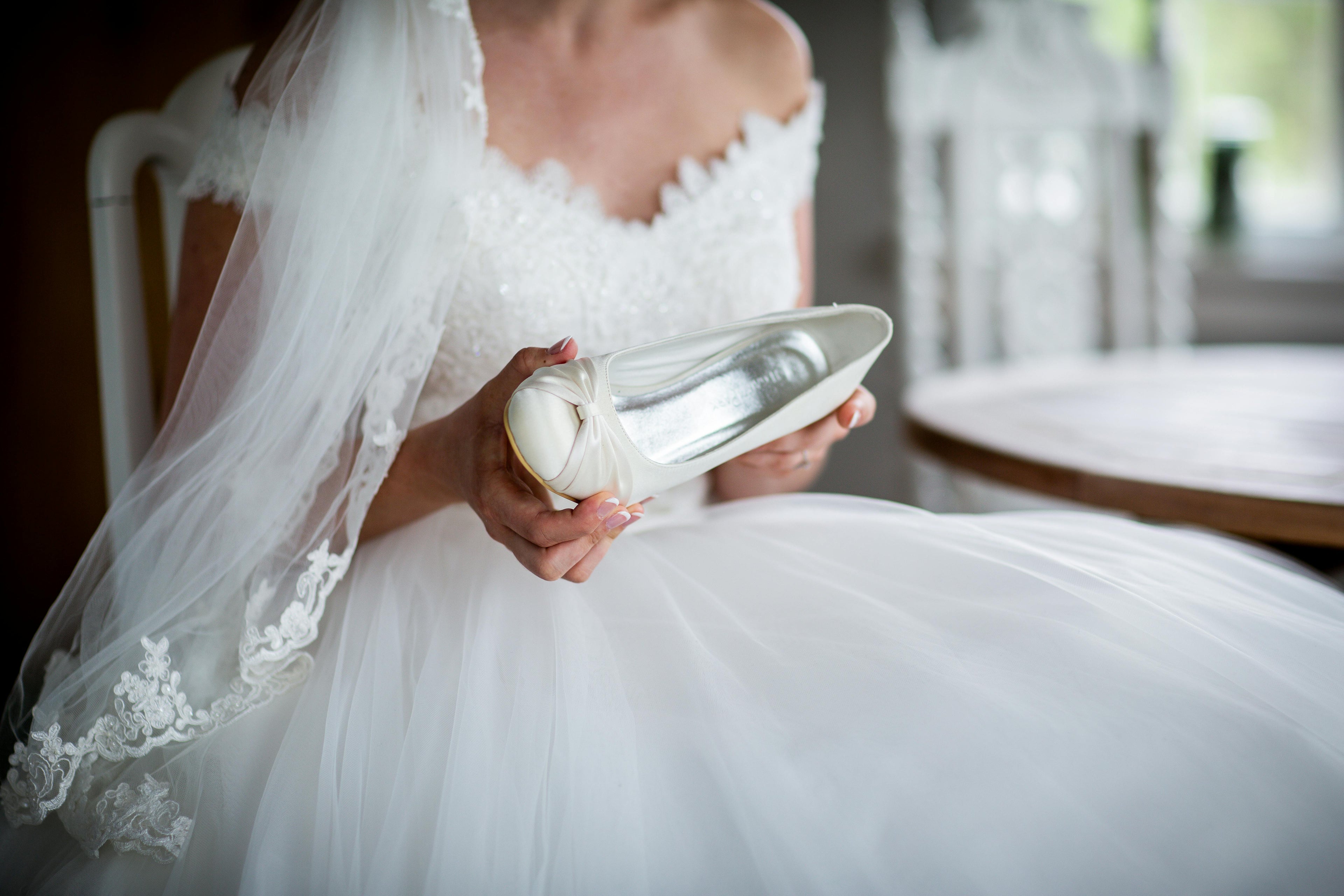 Bride holding her wedding heels